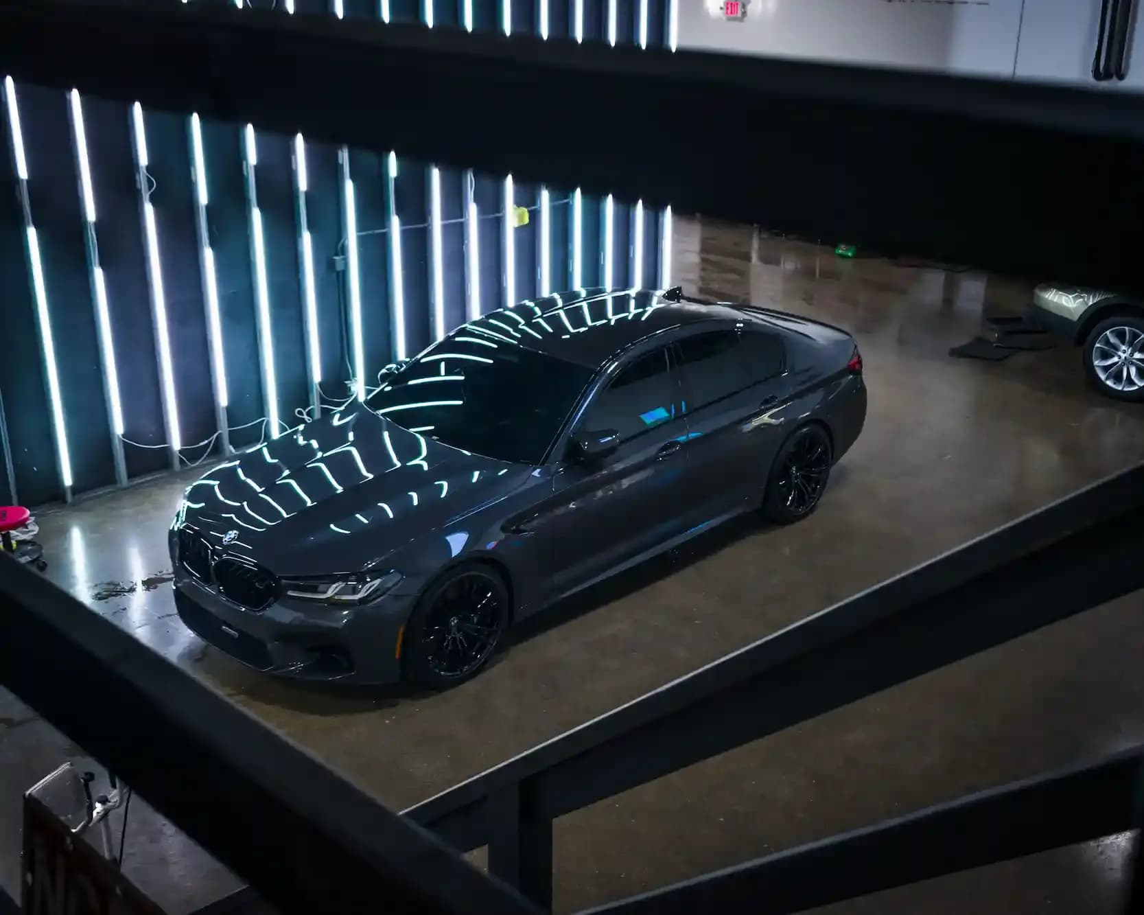 Grey sedan showcasing high gloss after a ceramic maintenance wash